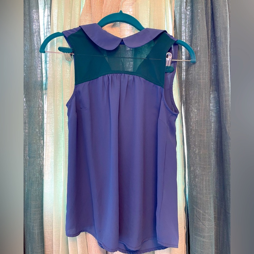 Color block periwinkle and teal sleeveless blouse with Peter Pan collar.